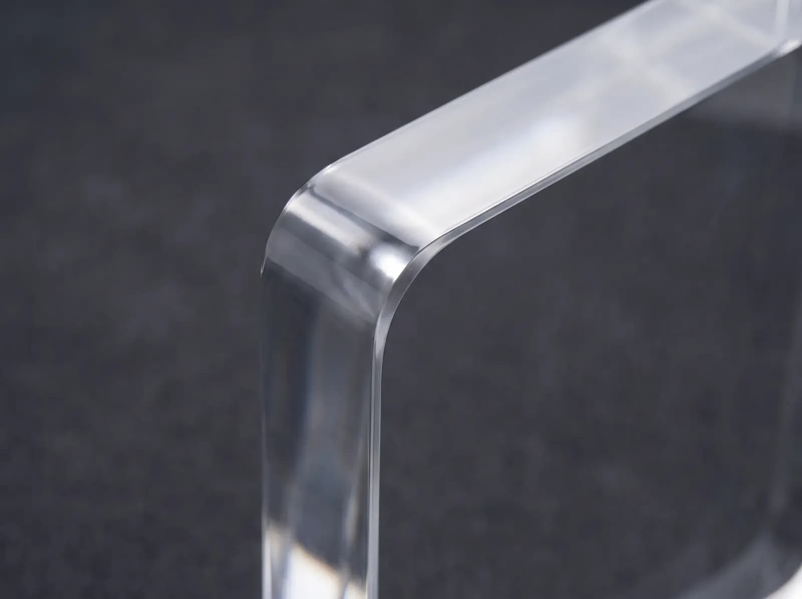 Close-up of the glossy laser-cut edge of an acrylic sheet