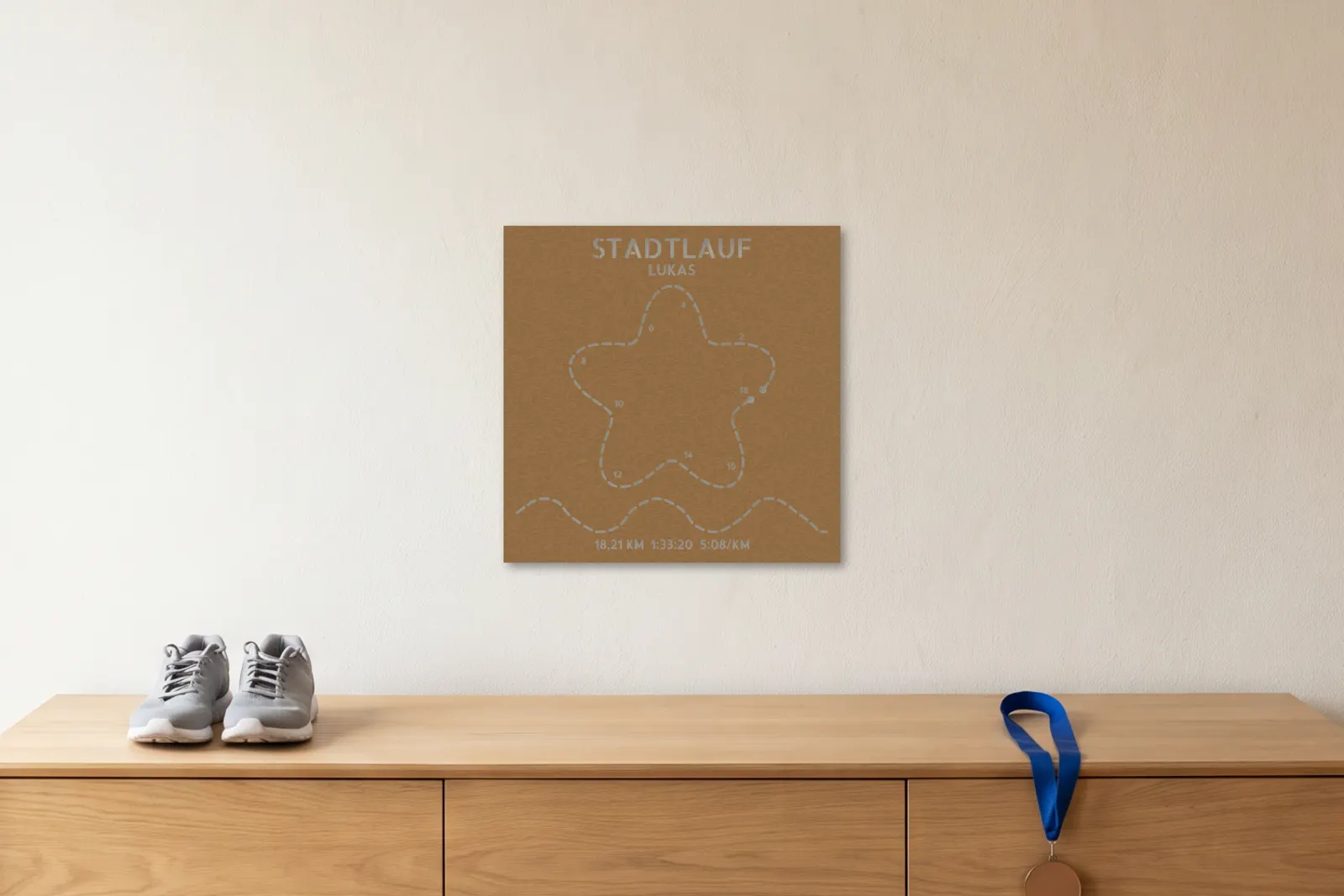 Póster de running de MDF en formato Large en una pared clara sobre un aparador de roble con zapatillas y una medalla